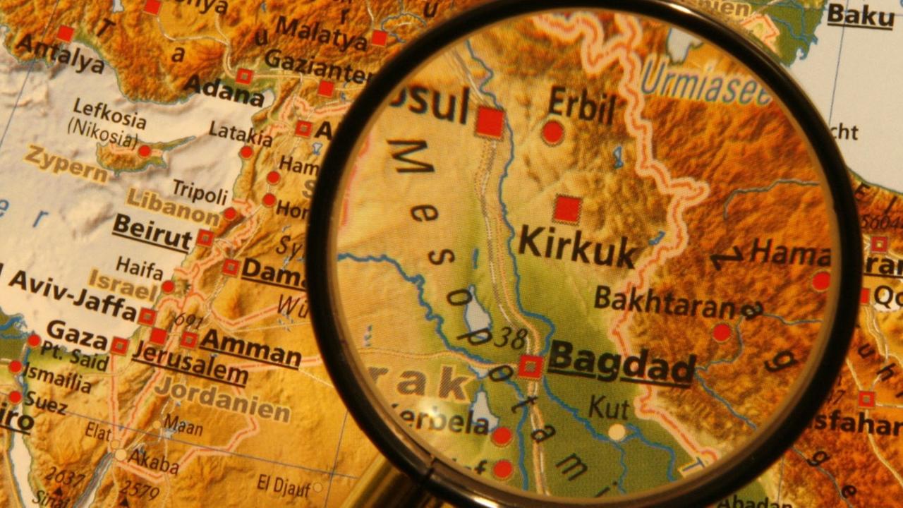 Eine Landkarte des Nahen Ostens, die irakische Hauptstadt Bagdad wird durch eine Lupe hervorgehoben. Eine Landkarte des Nahen Ostens, die irakische Hauptstadt Bagdad wird durch eine Lupe hervorgehoben.