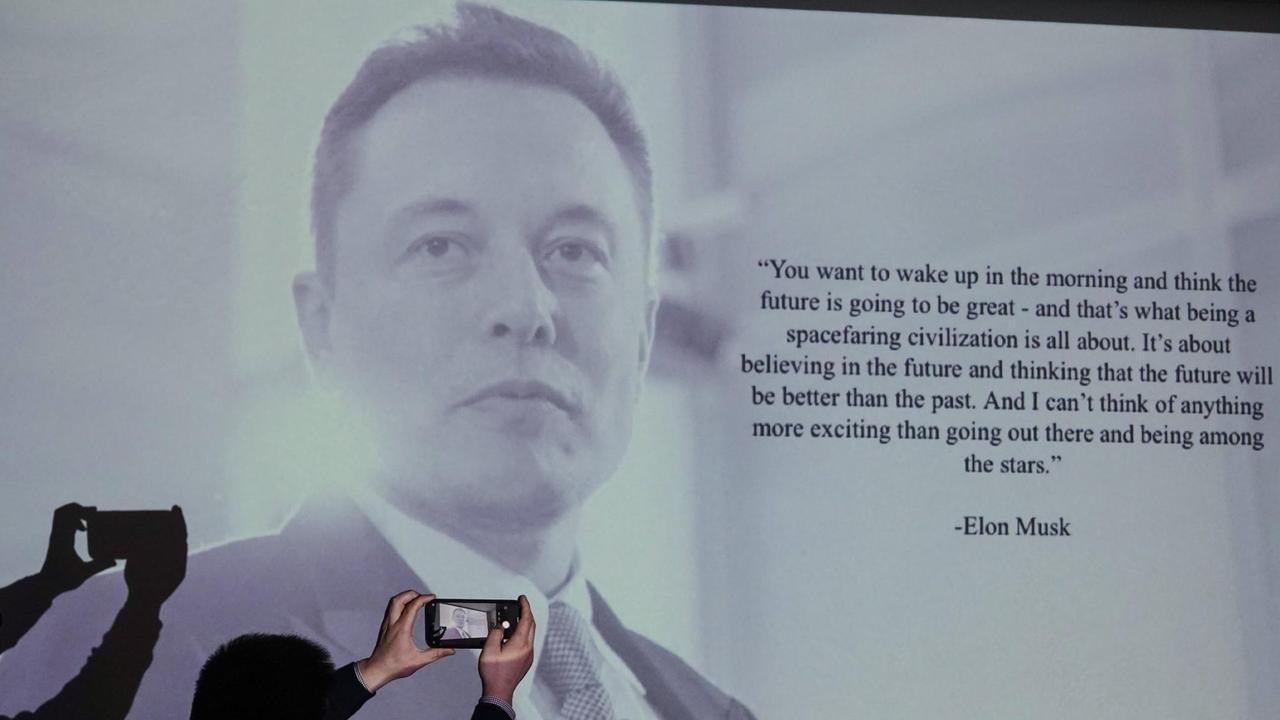 Auf einer Videoleinwand ist das Porträt des Tesla-Gründers Elon Musk zu sehen.