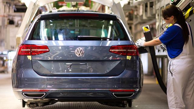 Eine Mitarbeiterin betankt am 09.09.2014 in der Produktion des Passat im Volkswagen Werk in Emden (Niedersachsen) einen Wagen.