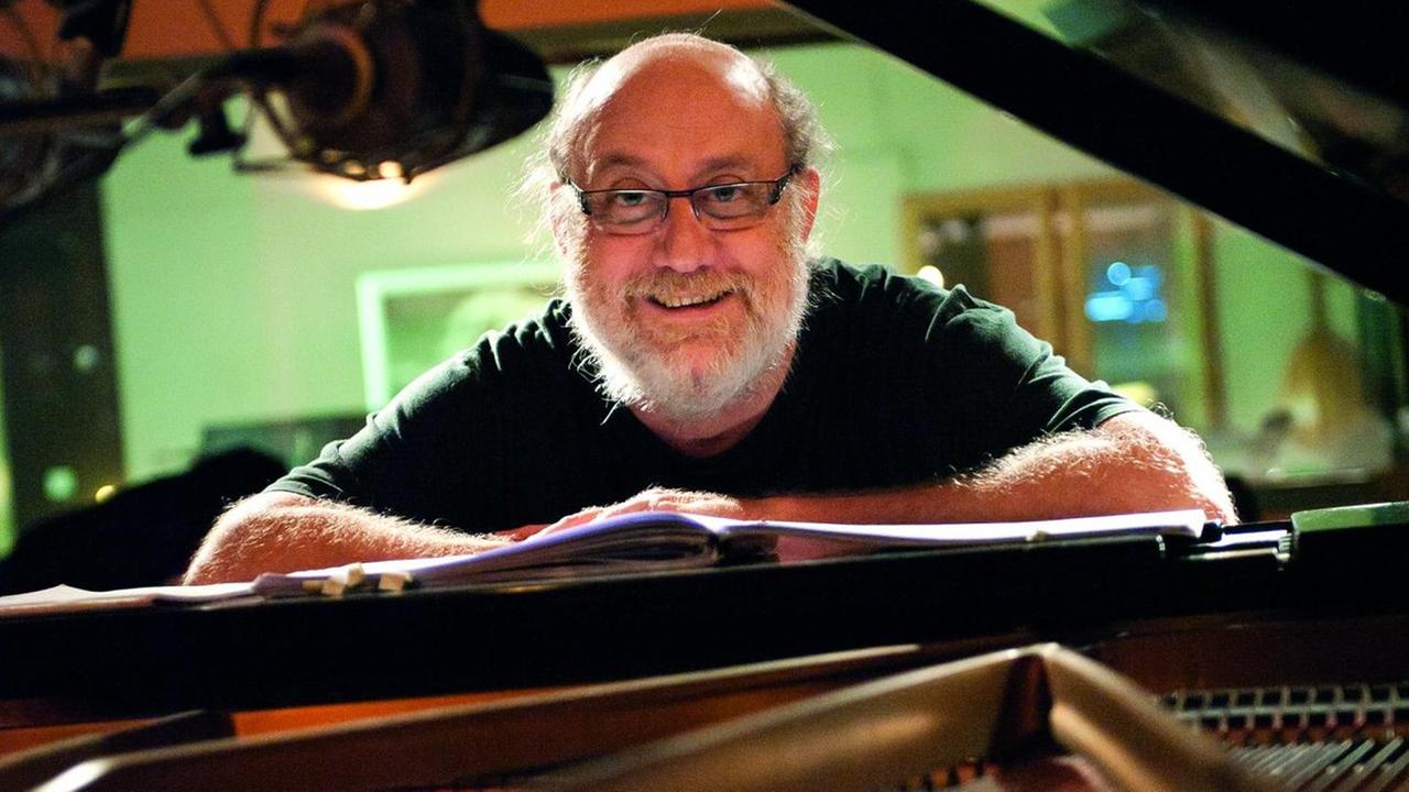 Pianist Andy Emler steht am offenem Flügel Pianist Andy Emler steht am offenem Flügel