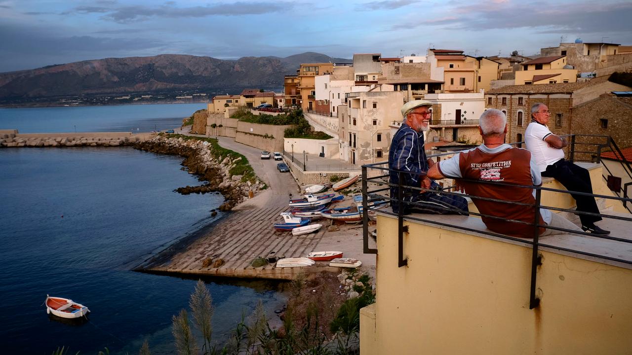 Trappeto - ein kleines sizilianisches Dorf nahe Palermo. Alte Männer verbringen ihre Zeit am Hafen.