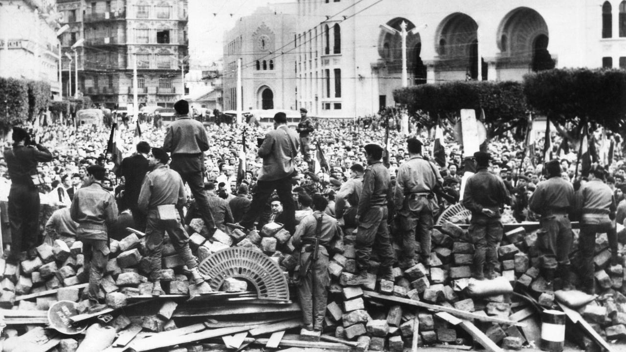 Im Hintergrund Algerien-Franzosen, Gegner der Unabhängigkeit Algeriens, während einer Demonstration Ende Januar 1960 in Algier. Im Vordergrund an den Barrikaden französische Fallschirmspringer. Im Hintergrund Algerien-Franzosen, Gegner der Unabhängigkeit Algeriens, während einer Demonstration Ende Januar 1960 in Algier. Im Vordergrund an den Barrikaden französische Fallschirmspringer.