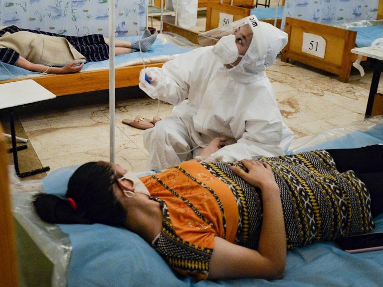 Patienten in Betten in einem Restaurant in Kirgisistan, das zum Hospital umgewandelt wurde.