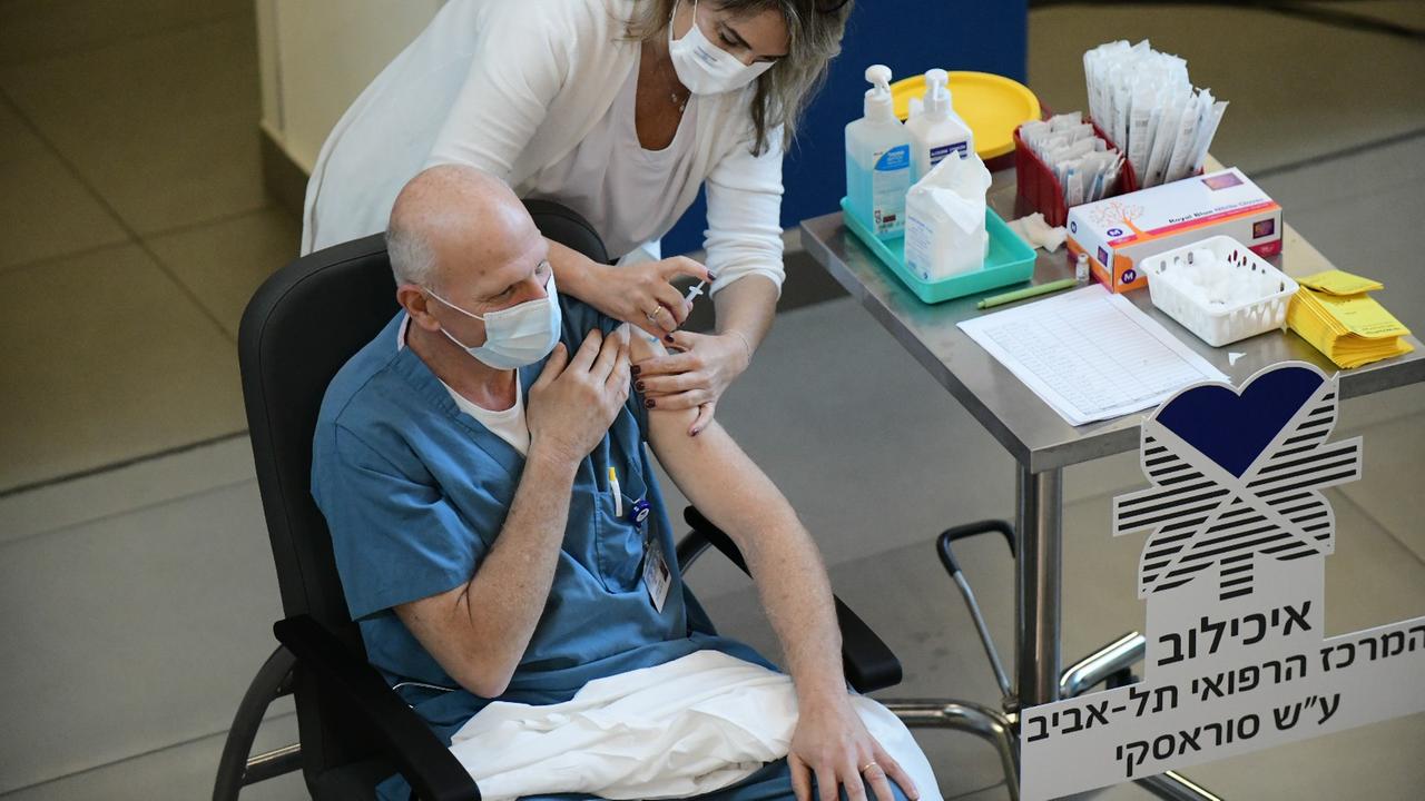 An Israeli medical worker receives a COVID-19 vaccine at the Sourasky Medical Center in Tel Aviv, Israel, Dec. 20, 2020. Israel launched on Sunday its COVID-19 inoculation drive as the infectious virus has quickly reared its ugly head again in the country. Health workers were the first to get the shots in the campaign that aims at vaccinating about 60,000 people per day, the Prime Minister's Office and the health ministry said in statements. ( An Israeli medical worker receives a COVID-19 vaccine at the Sourasky Medical Center in Tel Aviv, Israel, Dec. 20, 2020. Israel launched on Sunday its COVID-19 inoculation drive as the infectious virus has quickly reared its ugly head again in the country. Health workers were the first to get the shots in the campaign that aims at vaccinating about 60,000 people per day, the Prime Minister's Office and the health ministry said in statements. (