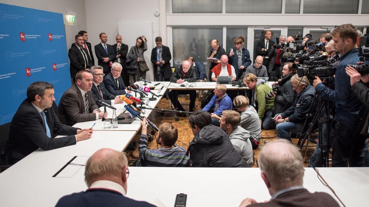 Pressesprecher Philipp Wedelich (l-r), Niedersachsens Innenminister Boris Pistorius (SPD), Bundesinnenminister Thomas de Maizière (CDU) und der Delegationsleiter der Nationalmannschaft, Reinhard Rauball sitzen am 17.11.2015 bei einer Pressekonferenz zum Fußball-Länderspiel Deutschland - Niederlande im Innenministerium in Hannover (Niedersachsen) vor Medienvertretern. Pressesprecher Philipp Wedelich (l-r), Niedersachsens Innenminister Boris Pistorius (SPD), Bundesinnenminister Thomas de Maizière (CDU) und der Delegationsleiter der Nationalmannschaft, Reinhard Rauball sitzen am 17.11.2015 bei einer Pressekonferenz zum Fußball-Länderspiel Deutschland - Niederlande im Innenministerium in Hannover (Niedersachsen) vor Medienvertretern.