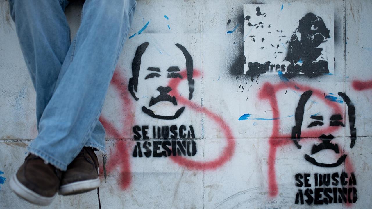"Mörder gesucht" steht an der Wand unter einer Abbildung des Staatschefs Daniel Ortega. Aufgenommen am 1. Juni 2018 in Managua, Nicaragua. 
