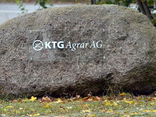 Ein Schild auf einem Feldstein weist in Oranienburg (Brandenburg) auf die Niederlassung der KTG Agrar SE hin.