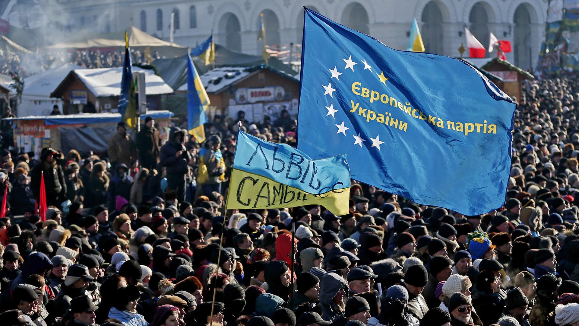 Menschen mit Ukraine- und EU-Flaggen auf dem Maidan in Kiew Menschen mit Ukraine- und EU-Flaggen auf dem Maidan in Kiew