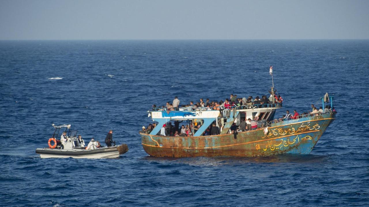 Die französische Marine begleitet ein Flüchtlingsboot im Mittelmeer zwischen Malta und Süditalien.