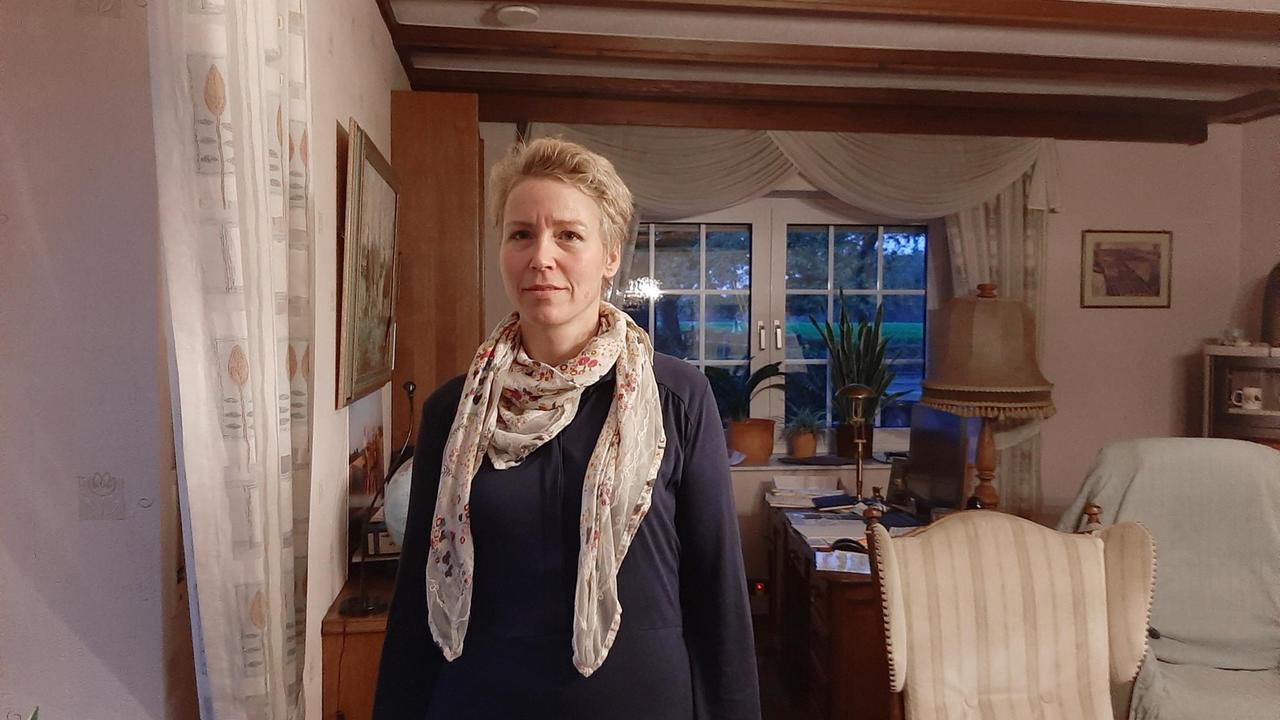 Simone Spiegels steht in ihrem Wohnzimmer und schaut in die Kamera Simone Spiegels steht in ihrem Wohnzimmer und schaut in die Kamera