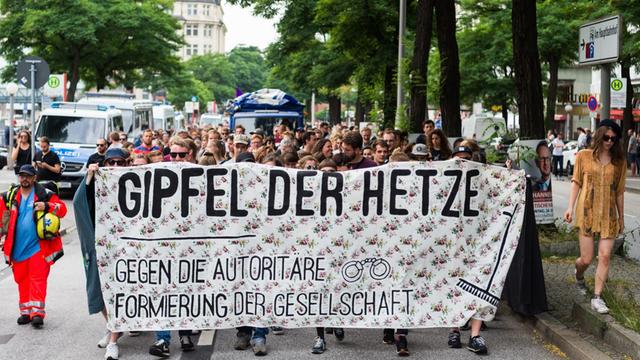 Demonstranten halten am 19.07.2017 in Hamburg ein Banner mit der Aufschrift "Gipfel der Hetze - gegen die autoritäre Formierung der Gesellschaft" in den Händen.
