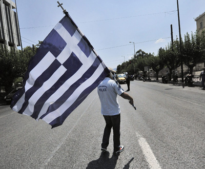 Ein Demonstrant mit einer griechischen Flagge Ein Demonstrant mit einer griechischen Flagge