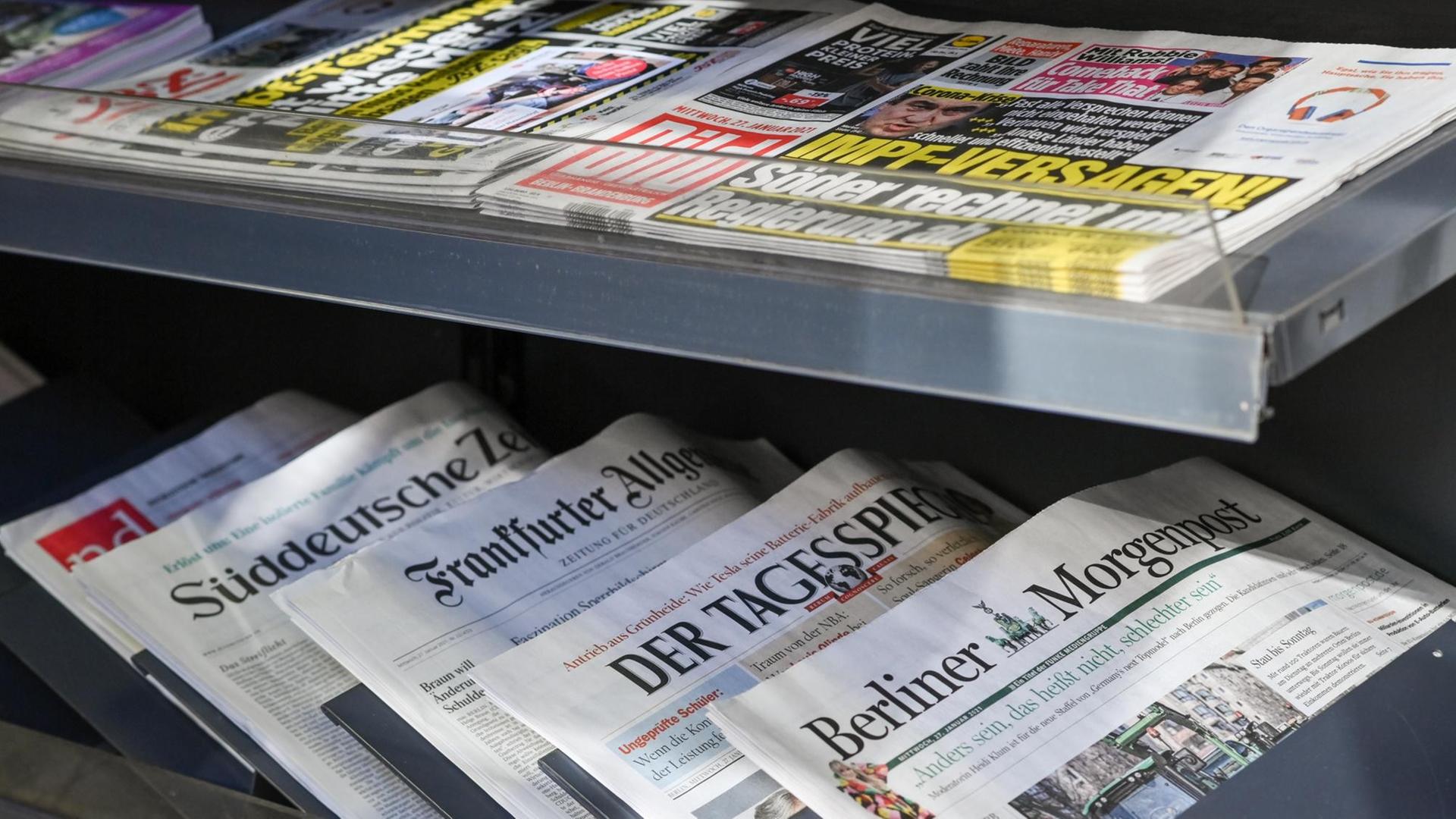 Zeitungen liegen in einer Auslage in einem Zeitschriftenladen. Zeitungen liegen in einer Auslage in einem Zeitschriftenladen.