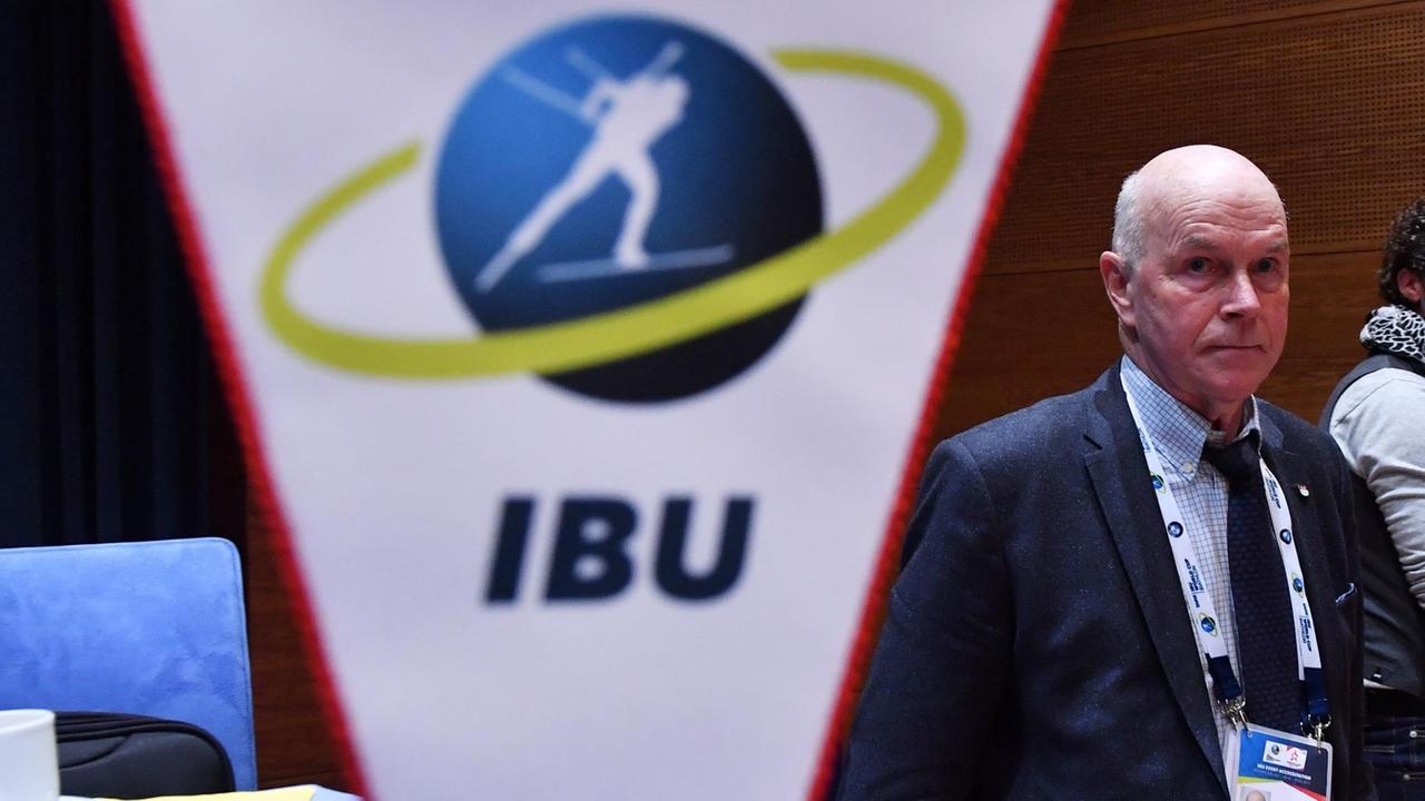 Anders Besseberg hinter einem Wimpel mit dem Logo der International Biathlon Union. Anders Besseberg hinter einem Wimpel mit dem Logo der International Biathlon Union.