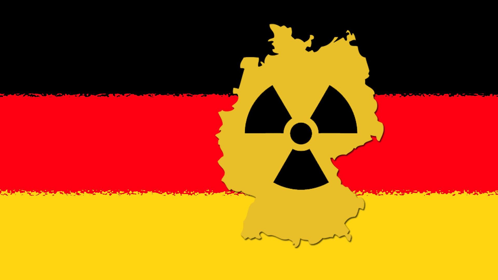 Zu sehen ist der Kartenumriss der Bundesrepublik mit einem Radioaktiv-Symbol und den Farben Schwarz-Rot-Gold im Hintergrund Zu sehen ist der Kartenumriss der Bundesrepublik mit einem Radioaktiv-Symbol und den Farben Schwarz-Rot-Gold im Hintergrund