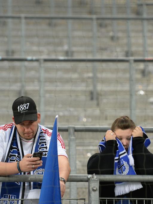 Hamburgs Fans stehen nach Spielende enttäuscht auf der Tribüne.