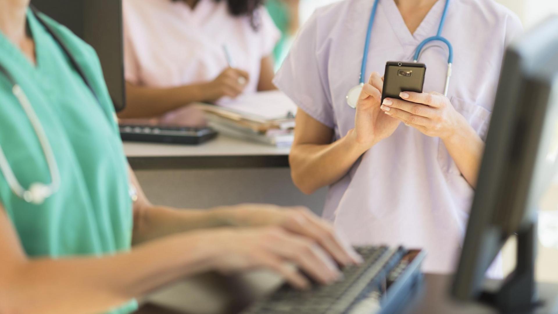 Ärtze und Pflegepersonal an Computern in einem Krankenhaus Ärtze und Pflegepersonal an Computern in einem Krankenhaus