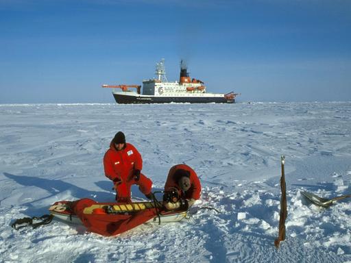Polarforscher in der Arktis . Im Hintergrund das deutsche Forschungsschiff Polarstern des Alfred-Wegener-Instituts (AWI) für Meeres- und Polarforschung. (Undatierte Aufnahme