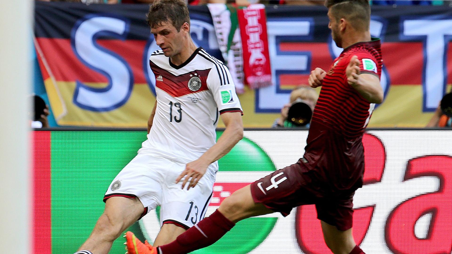 Stürmer Thomas Müller im Duell mit dem Portugiesen Miguel Veloso. Stürmer Thomas Müller im Duell mit dem Portugiesen Miguel Veloso.