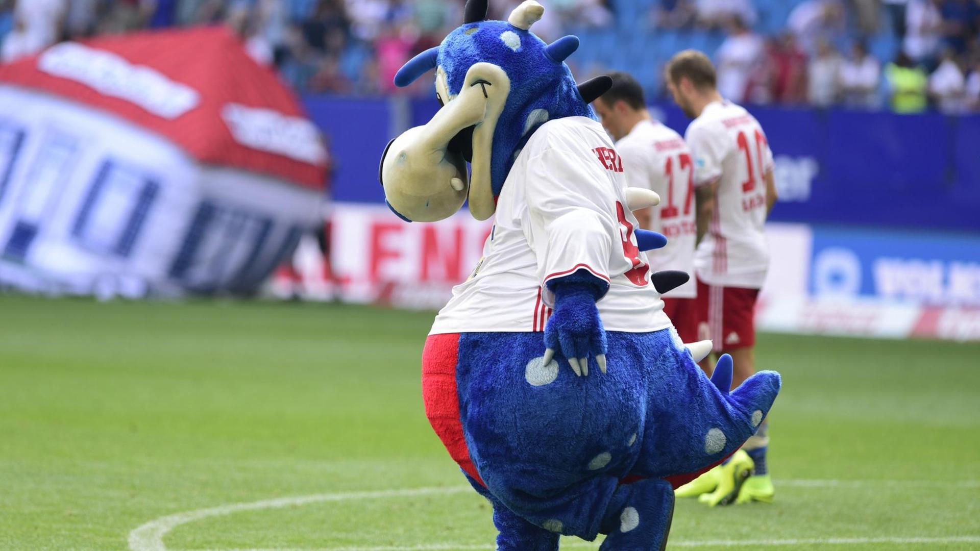 Das HSV-Maskottchen Dino Hermann sieht auf den Boden. Das HSV-Maskottchen Dino Hermann sieht auf den Boden.