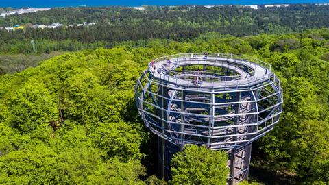 Besucher gehen auf den 40 Meter hohen Aussichtsturm als Herzstück des 1.250 Meter langen Baumwipfelpfades bei Prora auf der Insel Rügen