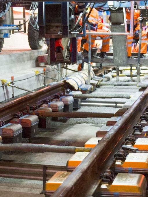 Arbeiter montieren im Oktober 2014 im Gotthard Basistunnel Schienen.