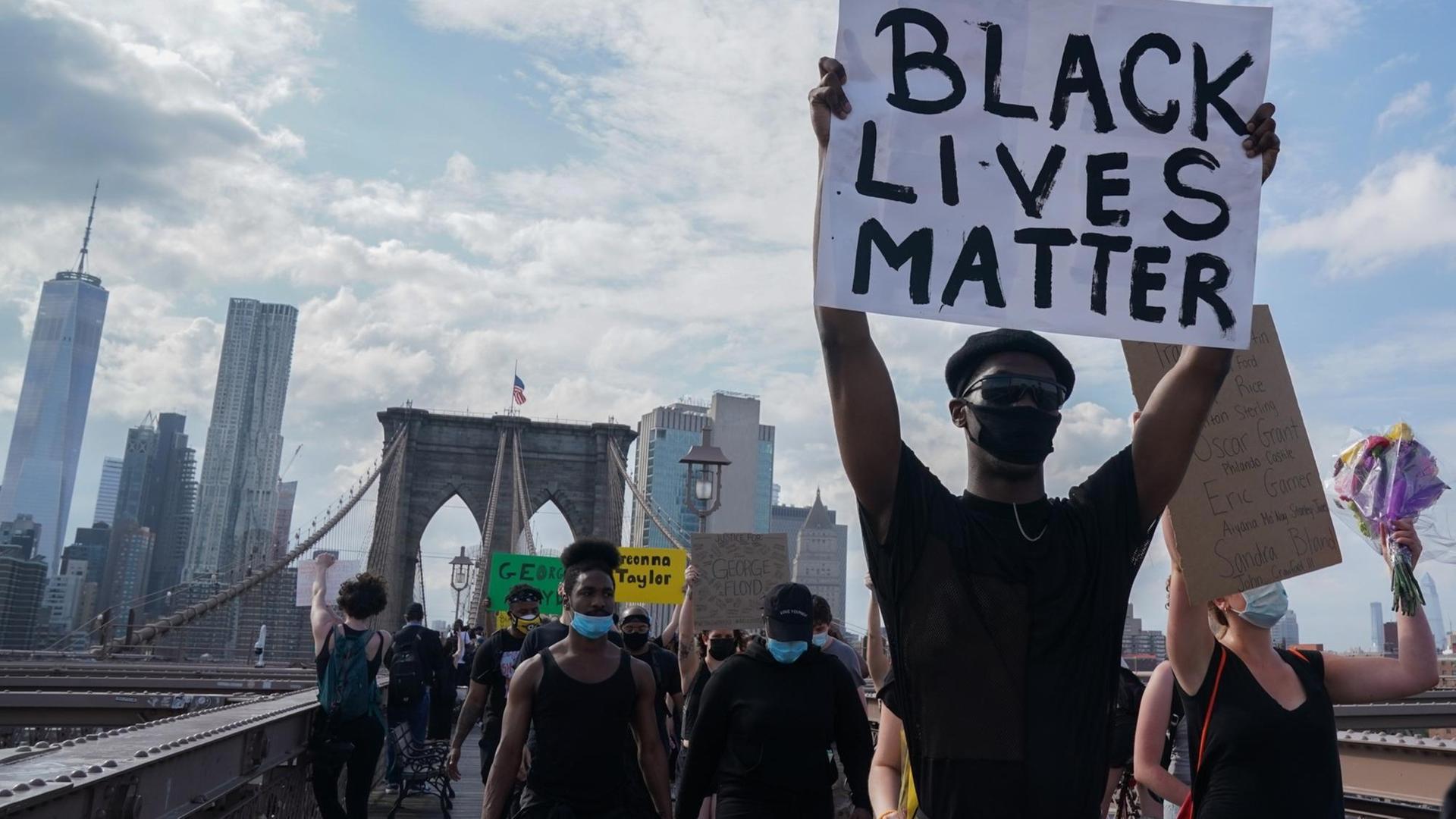 Protesters hold up signs as they demonstrate in outrage over the death of George Floyd by a Minneapolis police officer at a rally in lower Manhattan in New York, United States. Protesters hold up signs as they demonstrate in outrage over the death of George Floyd by a Minneapolis police officer at a rally in lower Manhattan in New York, United States.