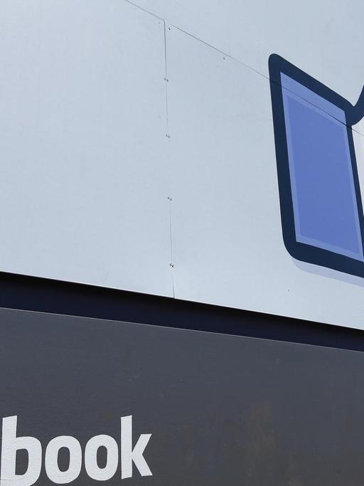 Ein großes Schild, das Facebook zeigt und sein Daumen-Symbol