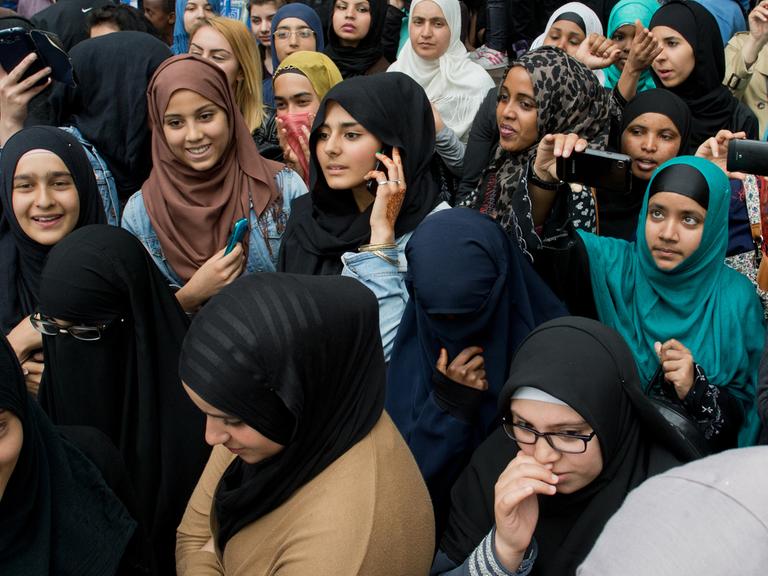 Junge Frauen verfolgen eine Kundgebung des radikalen Salafistenpredigers Pierre Vogel in Offenbach am Main.
