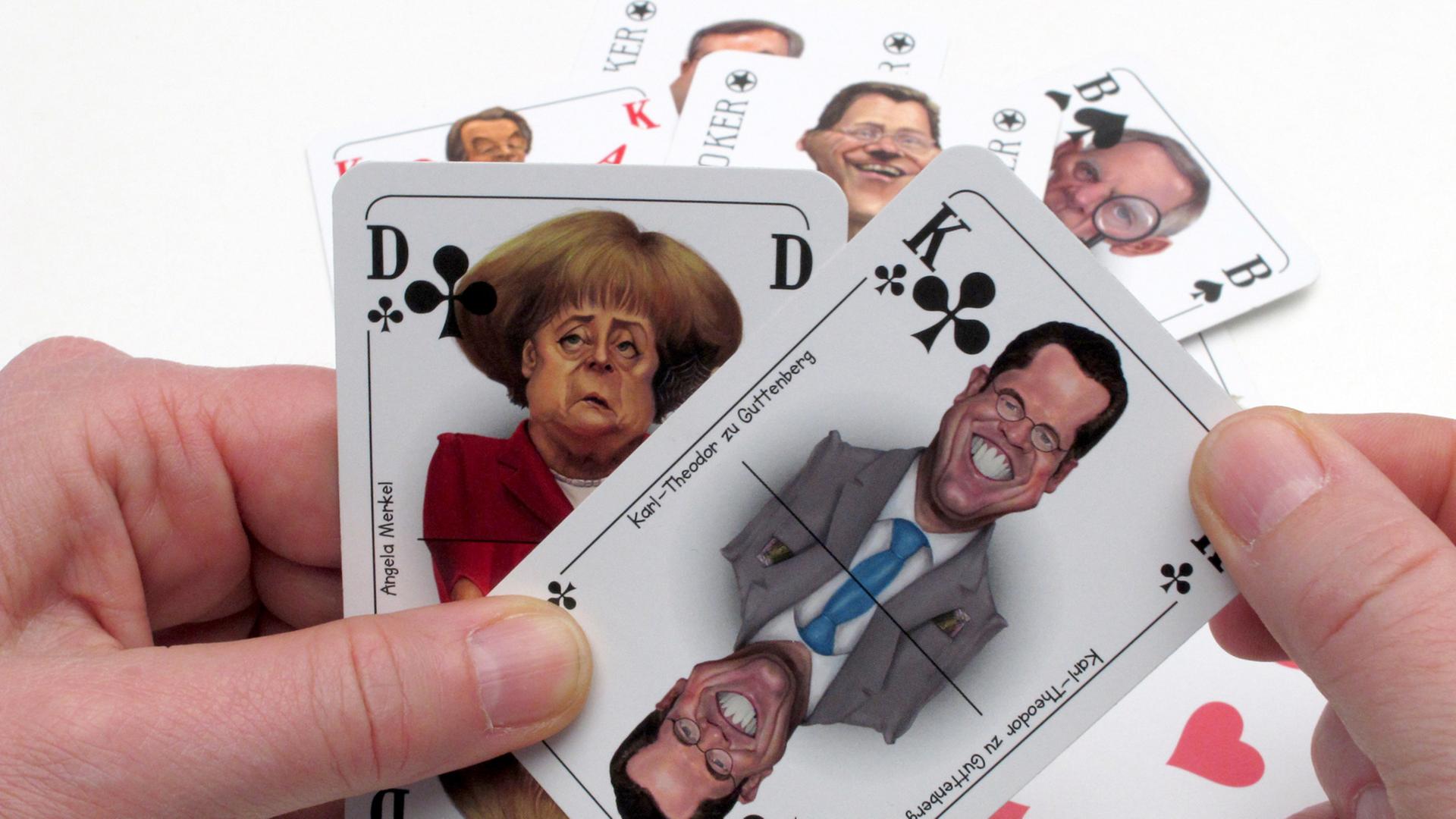Zwei humoristische Spielkarten zeigen Bundeskanzlerin Angela Merkel (CDU/links) und Karl Theodor zu Guttenberg/CSU). Zwei humoristische Spielkarten zeigen Bundeskanzlerin Angela Merkel (CDU/links) und Karl Theodor zu Guttenberg/CSU).