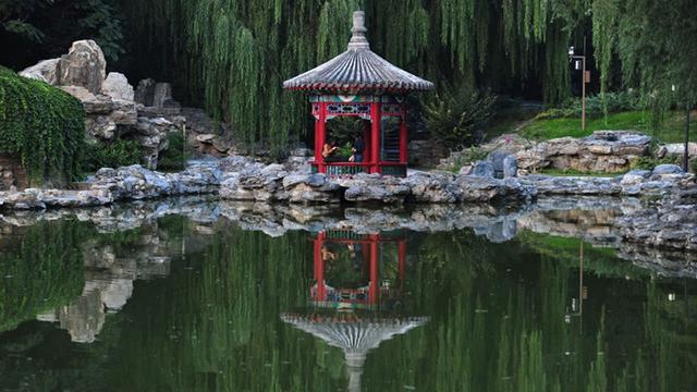 CHINA, BEIJING : Women sit in a traditional Chinese pavillion at a rock garden at a park in Beijing on September 28, 2010. Asia's developing economies should make long-term growth their top priority, the Asian Development Bank said as it lifted its 2010 growth forecast for the region.