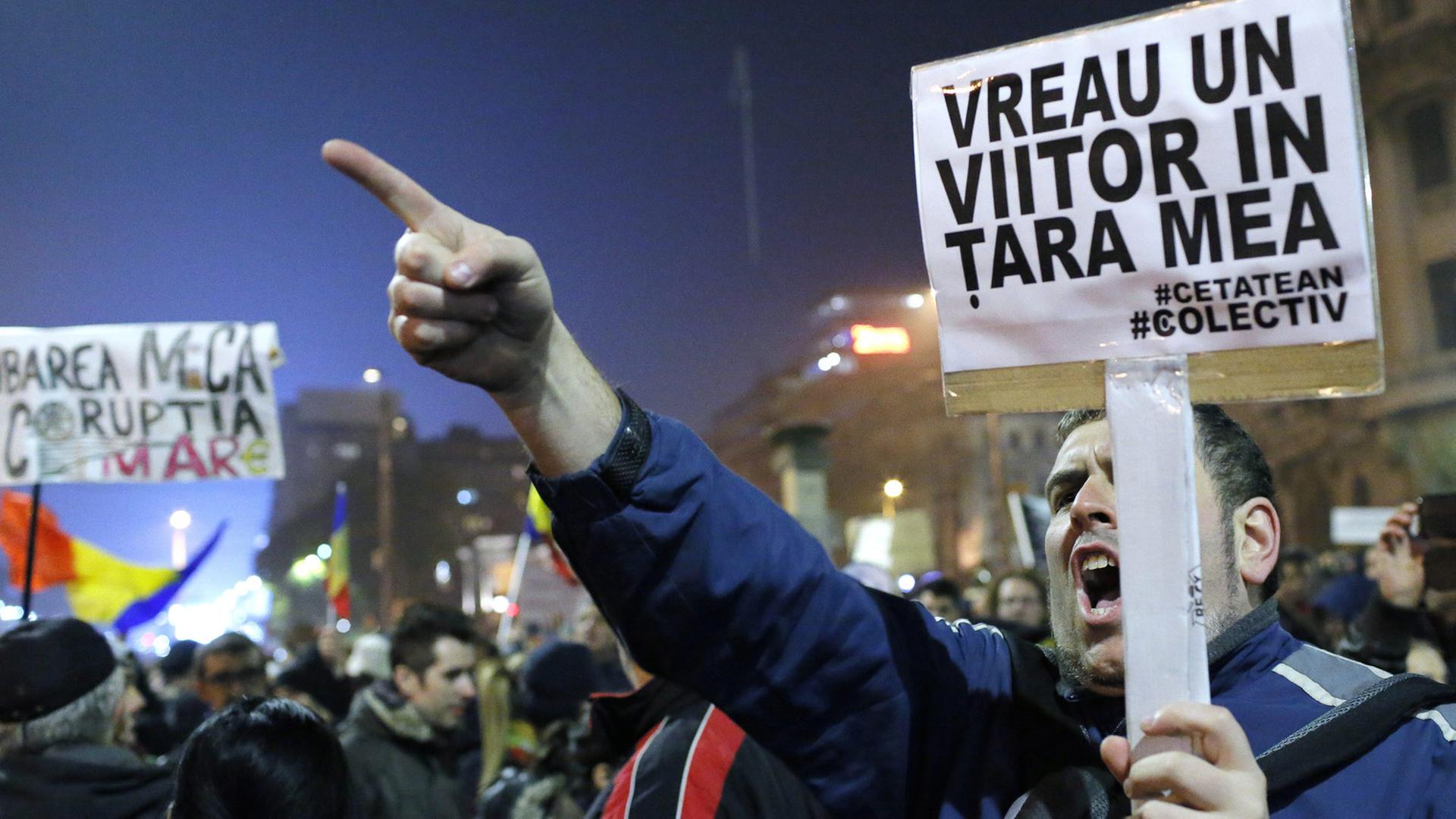 A Romanian man holding a placard that reads 'I WANT A FUTURE FOR MY COUNTRY' shouts slogans against the political establishment during a rally in reaction to the nightclub fire accident at University Plaza in downtown Bucharest, Romania, 06 November 2015. A Romanian man holding a placard that reads 'I WANT A FUTURE FOR MY COUNTRY' shouts slogans against the political establishment during a rally in reaction to the nightclub fire accident at University Plaza in downtown Bucharest, Romania, 06 November 2015.