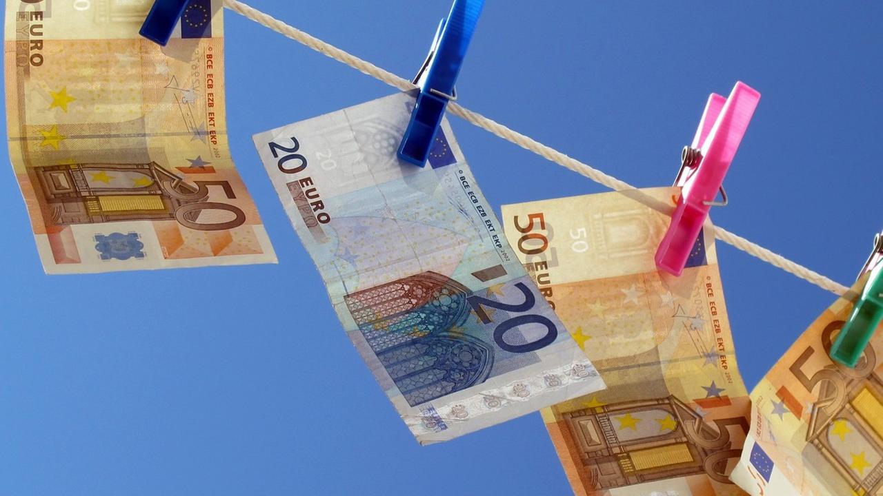Geldscheine hängen durch Wäscheklammern gehalten auf einer Wäscheleine. Geldscheine hängen durch Wäscheklammern gehalten auf einer Wäscheleine.