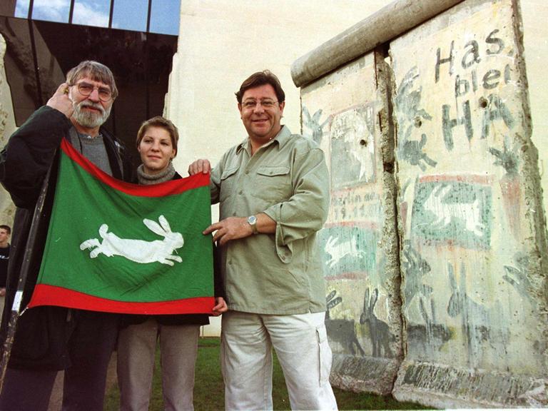 Manfred Butzmann (links) 1999 bei der Übergabe eines der Mauerstücke mit Graffiti auf der Ostseite an Caen.