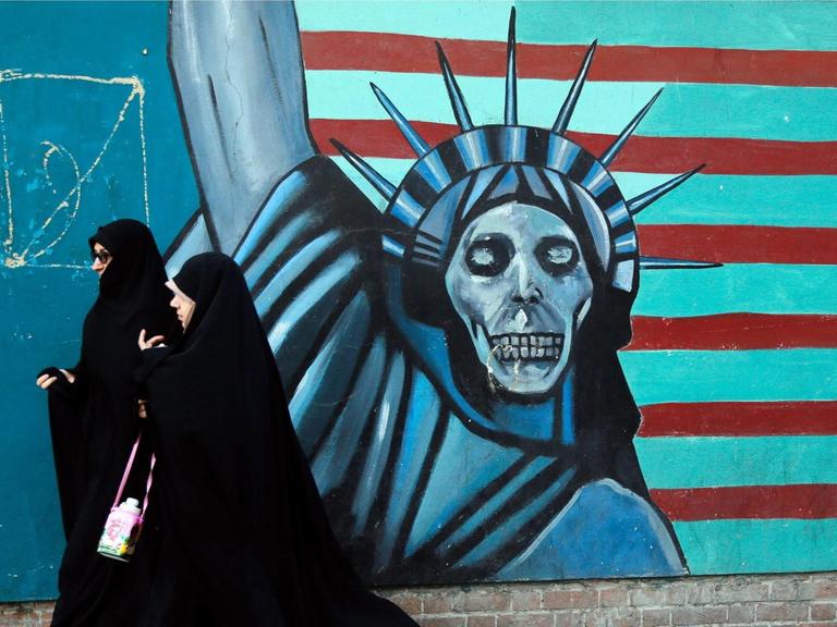 Ein Graffito zeigt die Freiheitsstatue mit Totenkopf und die US-Flagge stilisiert mit roten und hellblauen Streifen.