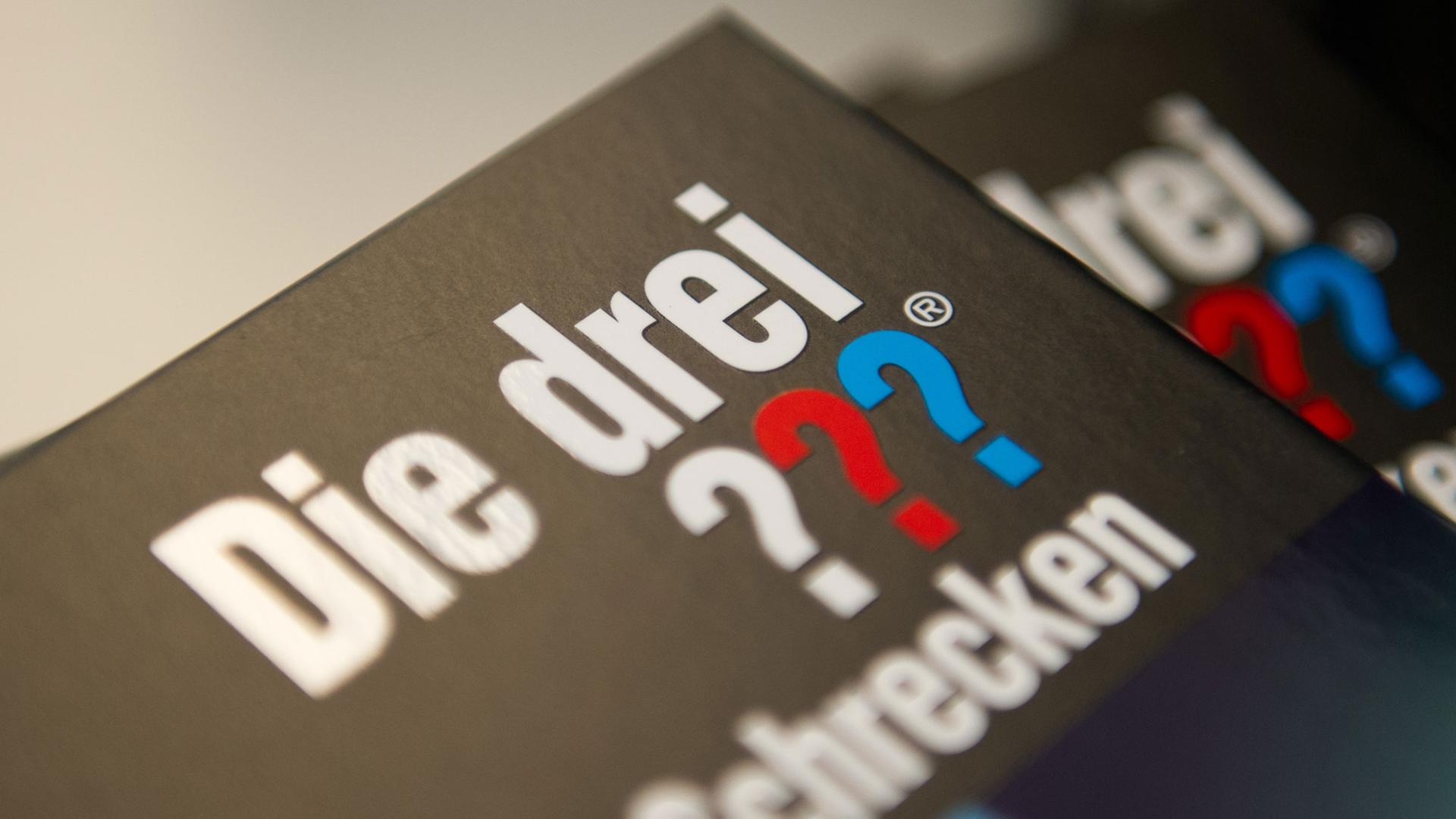 "Die drei ???" steht auf dem Cover eines Buches der Reihe "Die drei Fragezeichen". "Die drei ???" steht auf dem Cover eines Buches der Reihe "Die drei Fragezeichen".