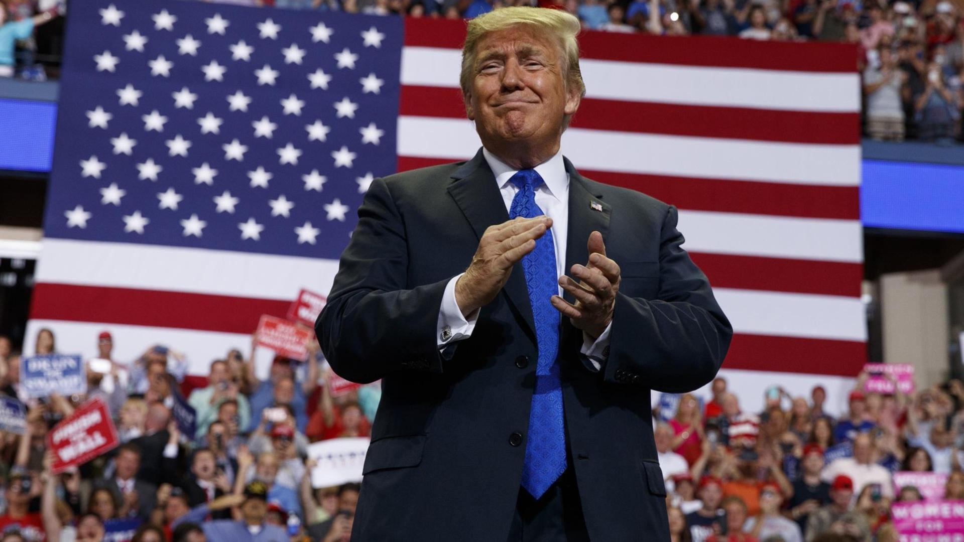 USA, Southaven: Donald Trump, Präsident der USA, spricht auf einer Kundgebung in der Landers Center Arena. Er klatscht in die Hände und verzieht das Gesicht zu einer Grimasse. Im Hintergrund sitzen Anhänger. USA, Southaven: Donald Trump, Präsident der USA, spricht auf einer Kundgebung in der Landers Center Arena. Er klatscht in die Hände und verzieht das Gesicht zu einer Grimasse. Im Hintergrund sitzen Anhänger.