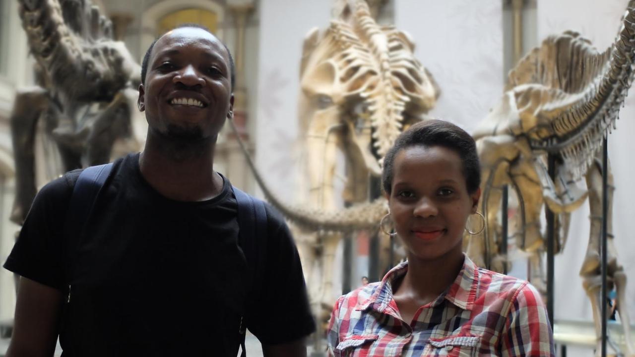 Erica Mela und Frank James Wajega vor dem Skelett des Dinosauriers im Naturkundemuseum.