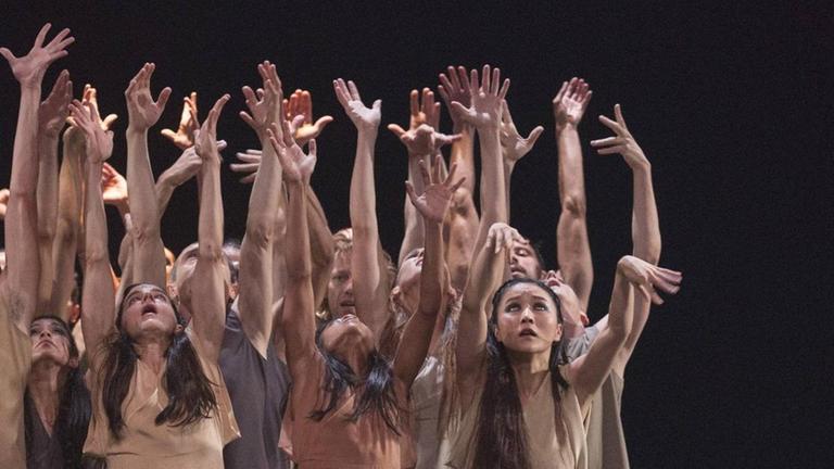 Bei einer Ballettaufführung recken sich viele Hände agressiv in die Höhe. Bei einer Ballettaufführung recken sich viele Hände agressiv in die Höhe.