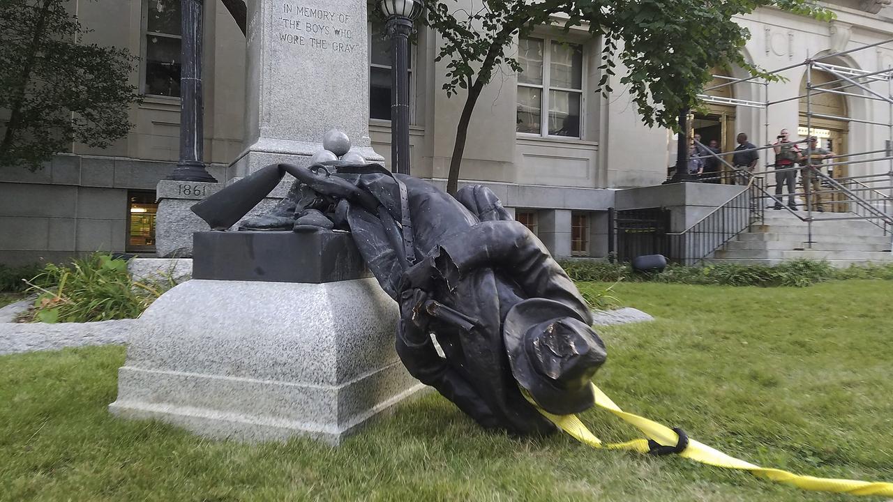 Eine Soldaten-Statue liegt umgestürzt am Boden Eine Soldaten-Statue liegt umgestürzt am Boden