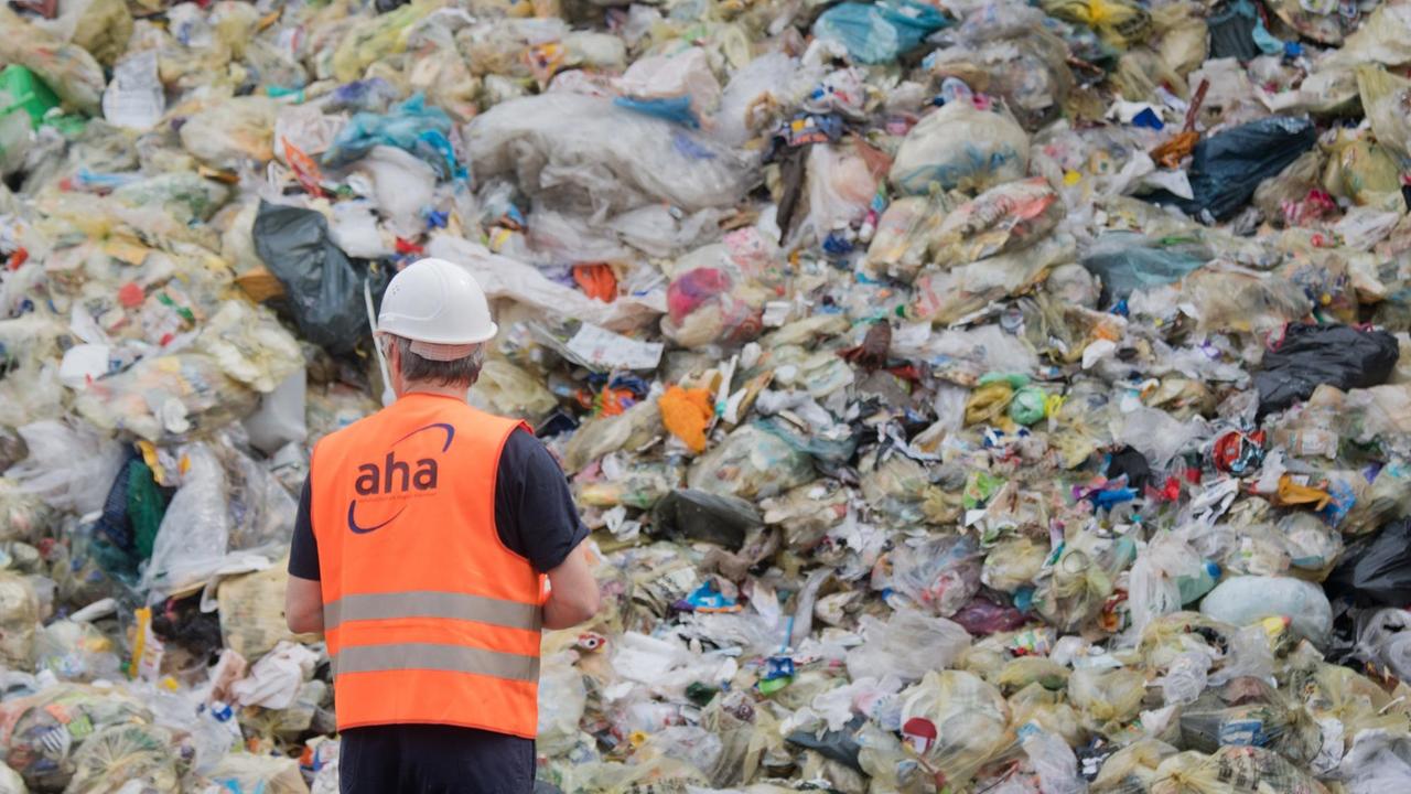 16.04.2018, Niedersachsen, Hannover: Leichtverpackungen und Gelbe Säcke liegen auf der Deponie des «aha Zweckverband Abfallwirtschaft Region Hannover», im Vordergrund läuft ein Mitarbeiter. 16.04.2018, Niedersachsen, Hannover: Leichtverpackungen und Gelbe Säcke liegen auf der Deponie des «aha Zweckverband Abfallwirtschaft Region Hannover», im Vordergrund läuft ein Mitarbeiter.
