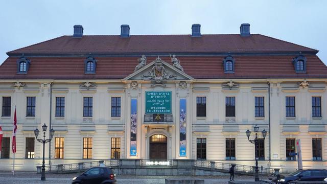 Das Jüdisches Museum in Berlin von außen, ein weißes Gebäude, davor Autos.