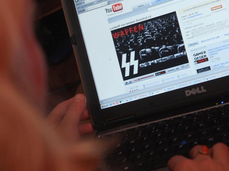 Das Bild zeigt einen Screenshot von der Videoplattform YouTube, auf dem Neonazi-Symbolen abgebildet sind.