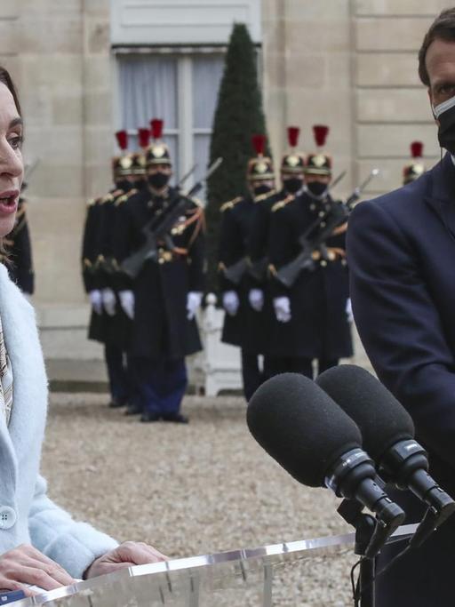 Moldova's President Maia Sandu, left, and France's President Emmanuel Macron meets the media prior to a working lunch at the Elysee Palace in Paris, Thursday, Feb. 4, 2021. Moldova's President Maia Sandu is in Paris for bilateral talks with France's President Emmanuel Macron. (AP Photo/Michel Euler)