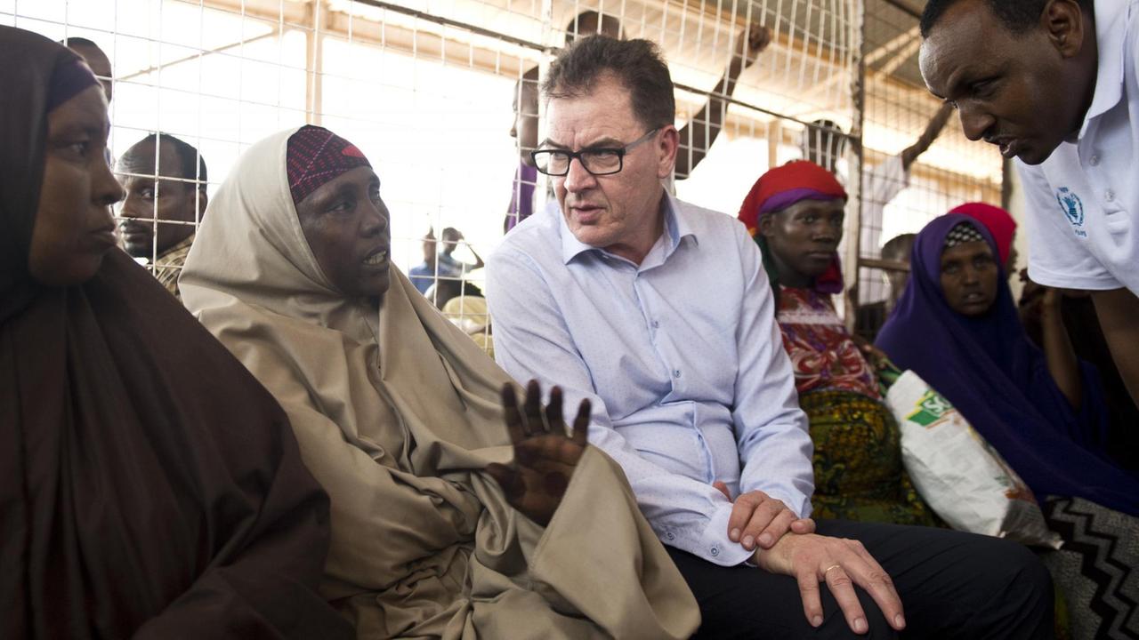 Bundesentwicklungsminister Gerd Müller (CSU) unterhält sich im März 2016 im Flüchtlingscamp Dadaab mit einer Frau.