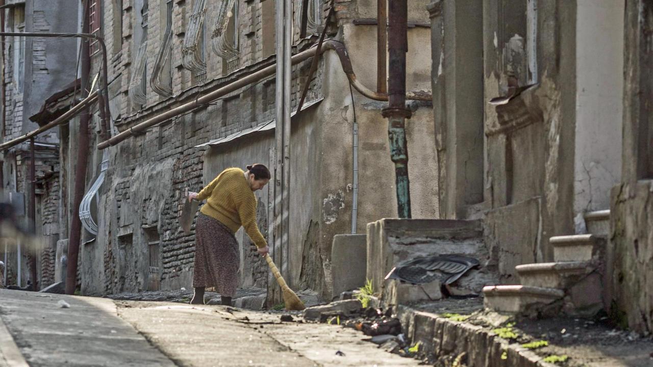 Ein Frau fegt eine Strasse in Tiflis. Ein Frau fegt eine Strasse in Tiflis.