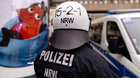 Polizisten schützen Demonstranten gegen den WDR bei den Protesten gegen das von einem Kinderchor gesungene Satire-Lied "Meine Oma ist ne alte Umweltsau" von WDR2 am WDR-Gebäude in der Breite Straße in Köln.