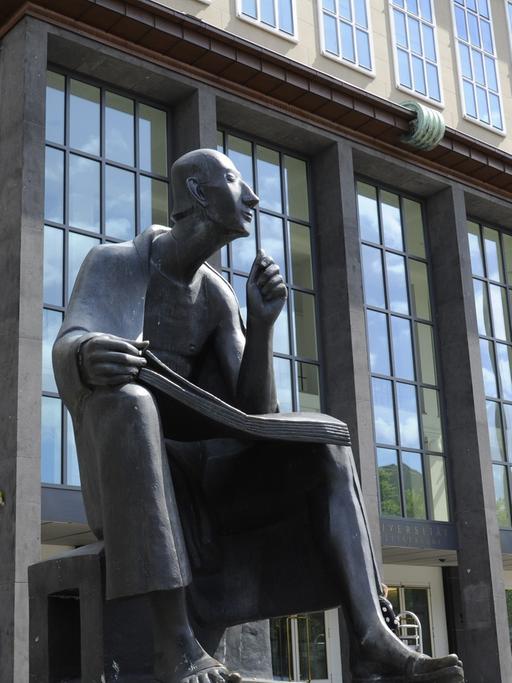 Statue des sitzenden Albertus Magnus vor dem Hauptgebäude der Universität zu Köln.