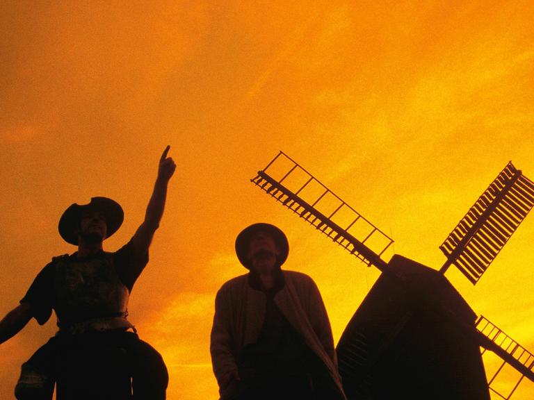 Don Quijote mit Sancho Pansa vor einer Windmühle.