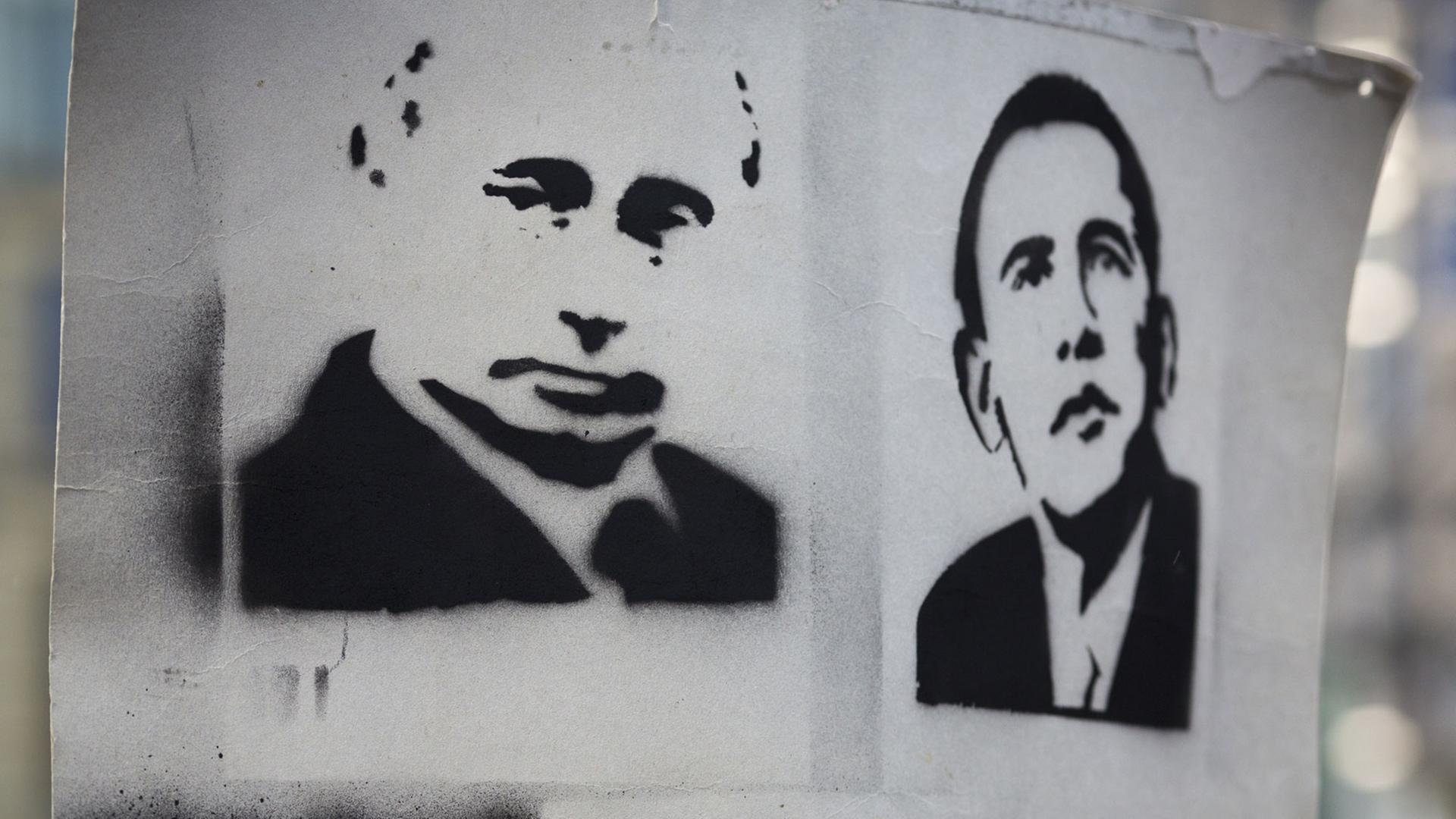 "Habt euch lieb" steht am Potsdamer Platz in Berlin auf einem Plakat mit den Portraits von Wladimir Putin und Barack Obama.